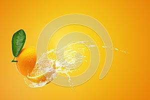 Water splashing on Fresh Sliced Ã¢â¬â¹Ã¢â¬â¹oranges and Orange fruit on Orange background